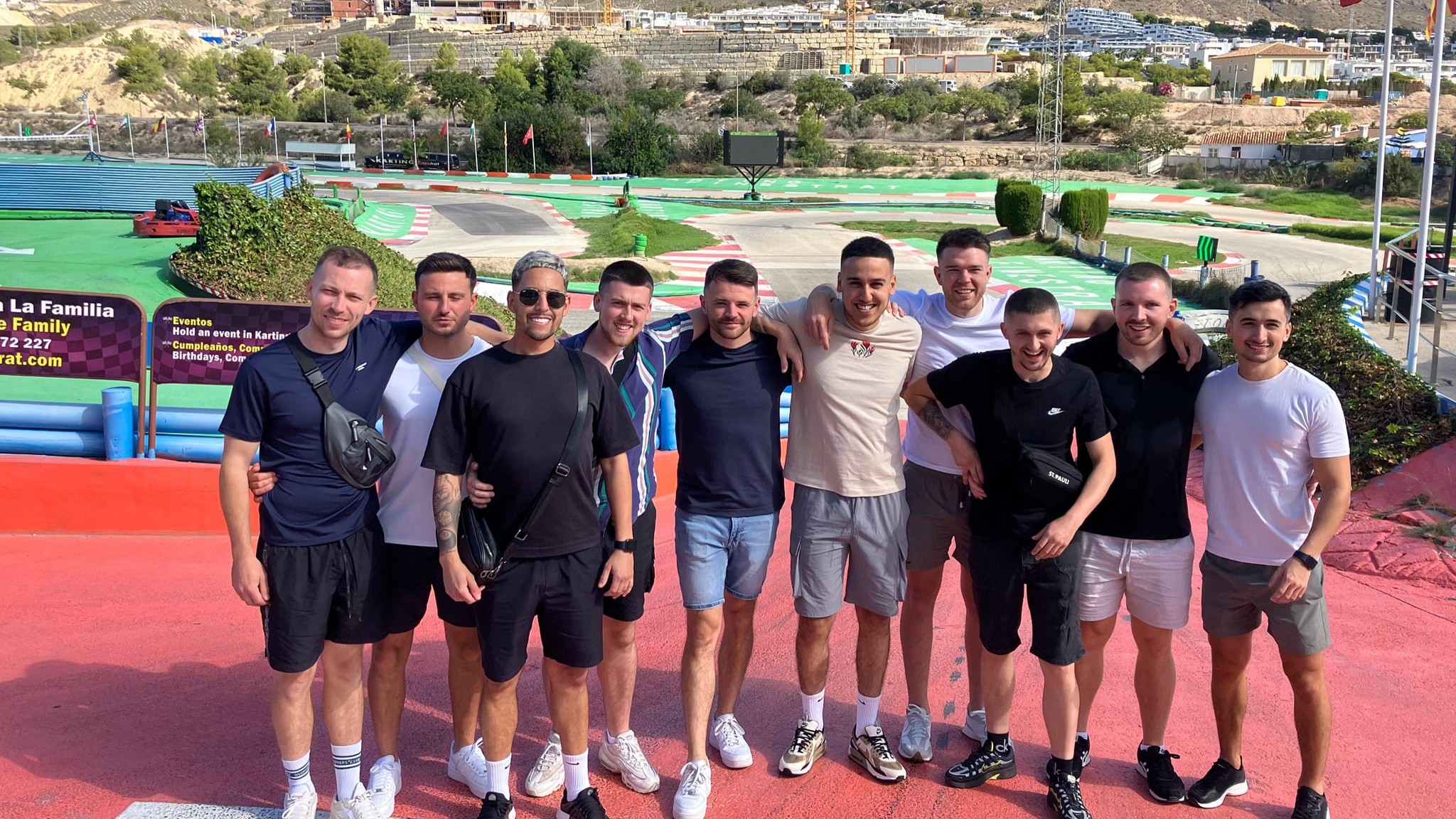 lads in arms in front of go karting track